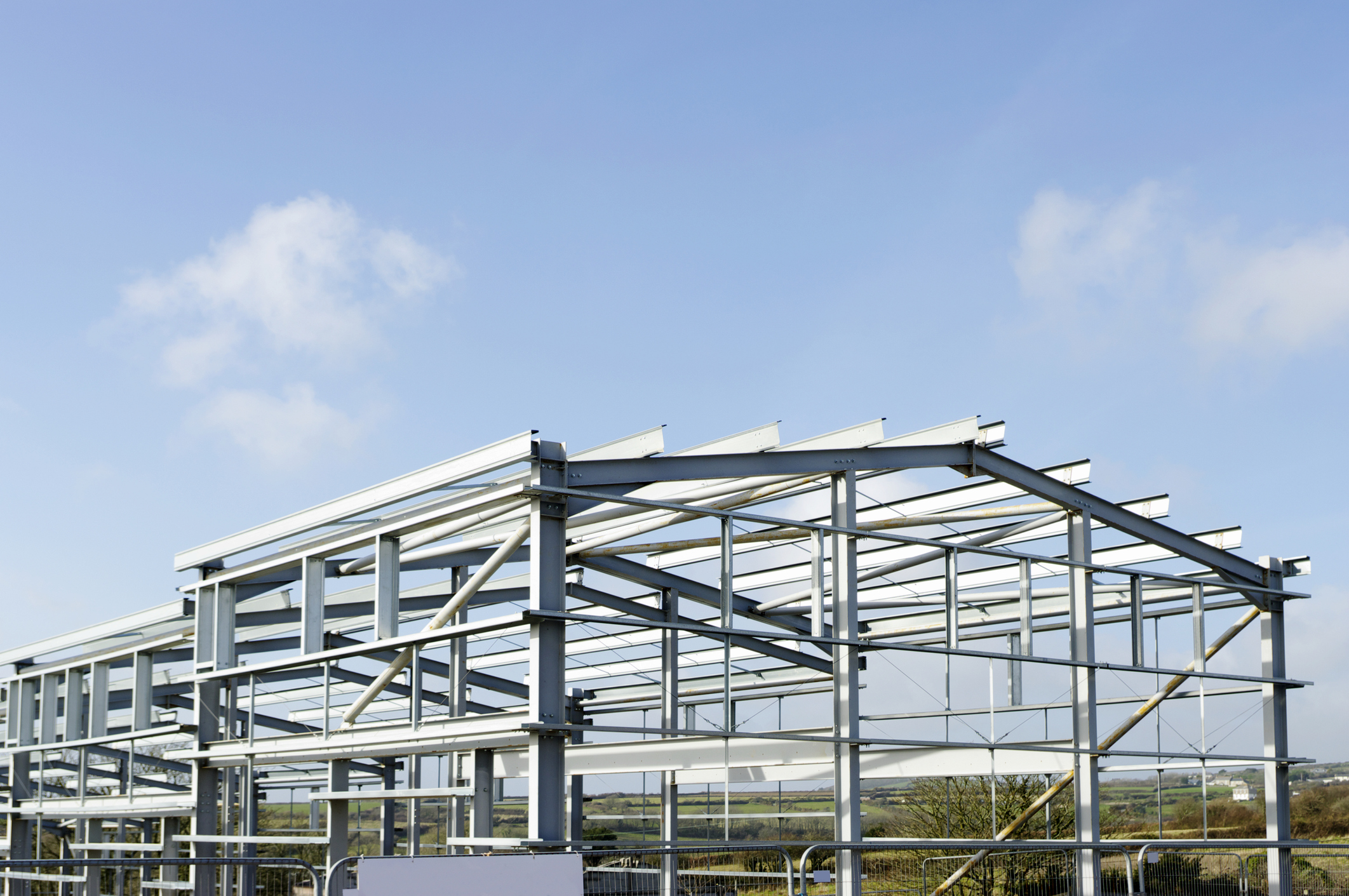 Structural Steelwork For New Industrial Building Against Blue Sky